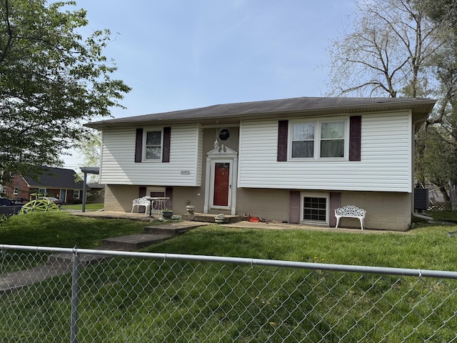 split foyer home featuring fence private yard and a front lawn