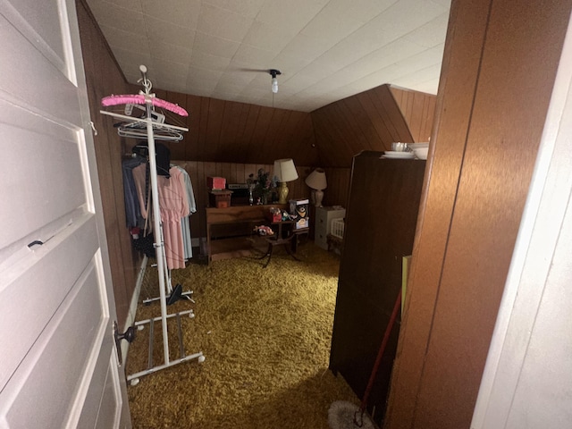 bonus room with carpet and wooden walls