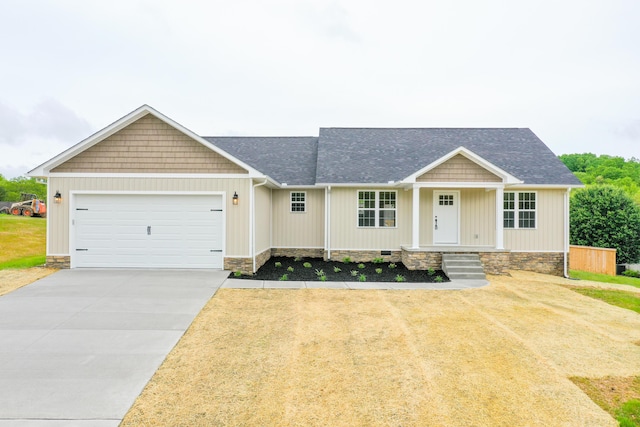 view of front of home with a garage, concrete driveway, roof with shingles, covered porch, and a front lawn