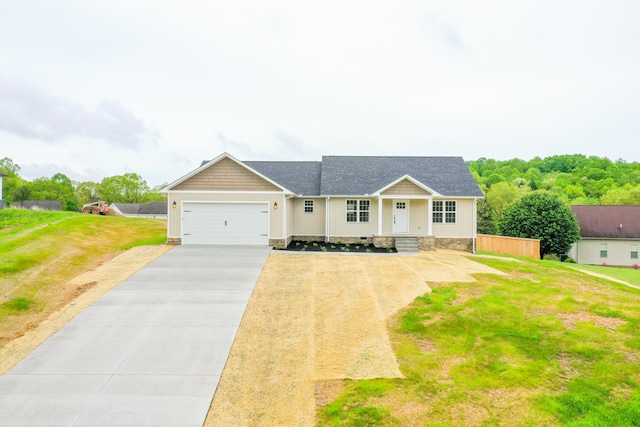 view of front of home featuring driveway, a garage, a front yard, and a shingled roof