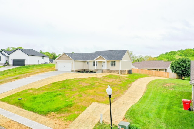 single story home with concrete driveway and an attached garage