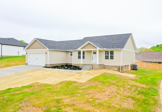 ranch-style house with cooling unit, driveway, an attached garage, a porch, and a shingled roof