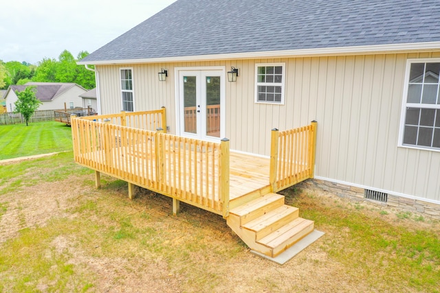 deck featuring french doors and a yard