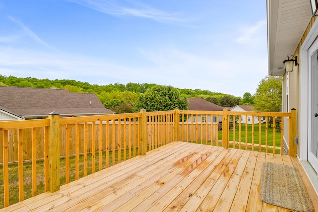 wooden deck with a lawn