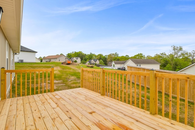 wooden deck with a residential view and a yard