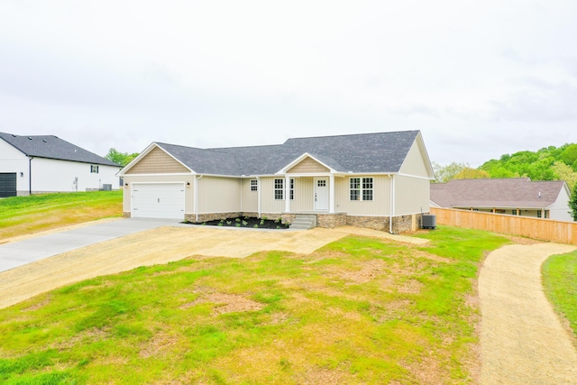 view of front of house featuring concrete driveway, cooling unit, and a garage