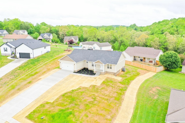 aerial view of residential area featuring a forest