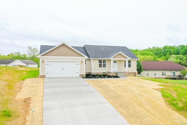 view of front facade with an attached garage, driveway, a front lawn, a shingled roof, and board and batten siding