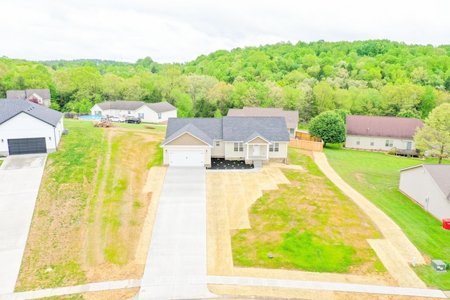 aerial view of property and surrounding area with a forest