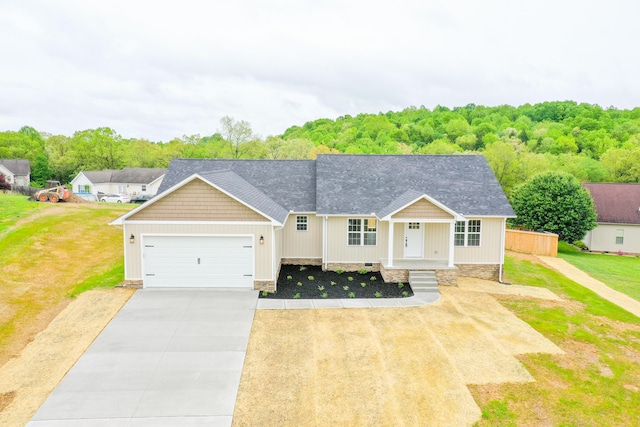 view of front of home with an attached garage, concrete driveway, and a front lawn