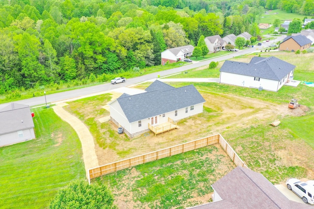 aerial view of residential area featuring a heavily wooded area