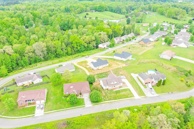 aerial view of residential area featuring a heavily wooded area