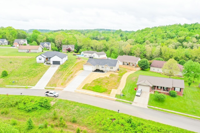 aerial view of residential area featuring a forest