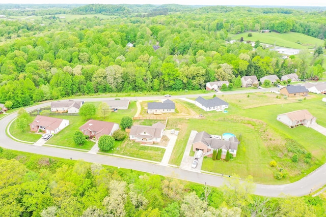 aerial perspective of suburban area featuring a heavily wooded area