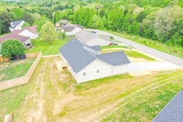 aerial view of residential area featuring a forest