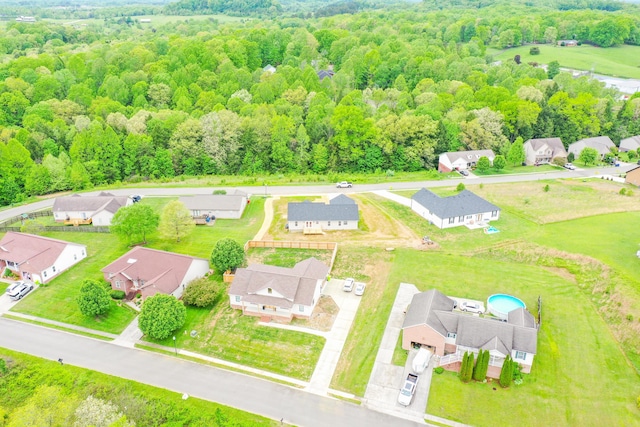 aerial view of residential area with a heavily wooded area