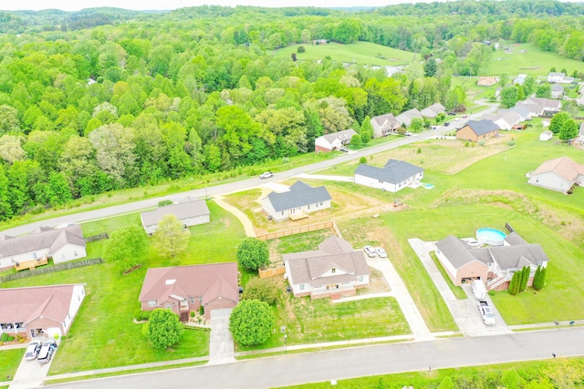aerial view of residential area featuring a heavily wooded area