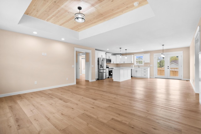 unfurnished living room with a raised ceiling, wooden ceiling, recessed lighting, light wood-style flooring, and baseboards