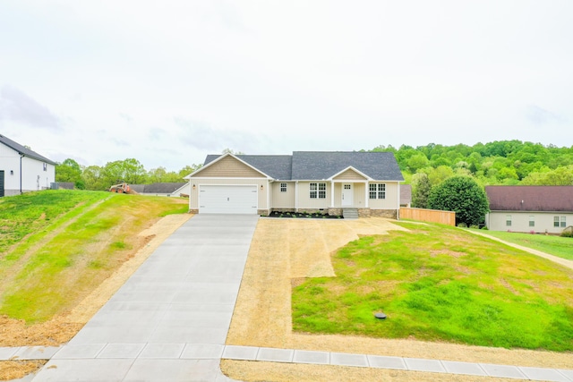 view of front facade with concrete driveway, an attached garage, and a front yard