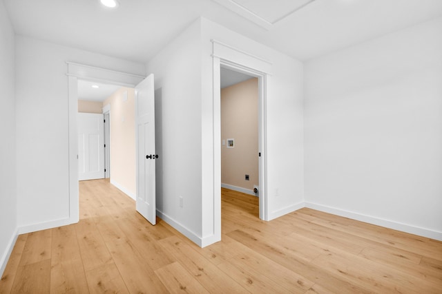 unfurnished room with light wood-type flooring, recessed lighting, and baseboards
