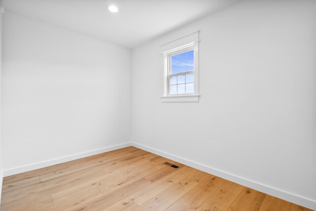 unfurnished room with baseboards, hardwood / wood-style flooring, and recessed lighting