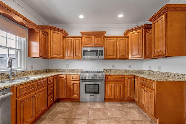 kitchen with stainless steel appliances, brown cabinets, ornamental molding, and a sink