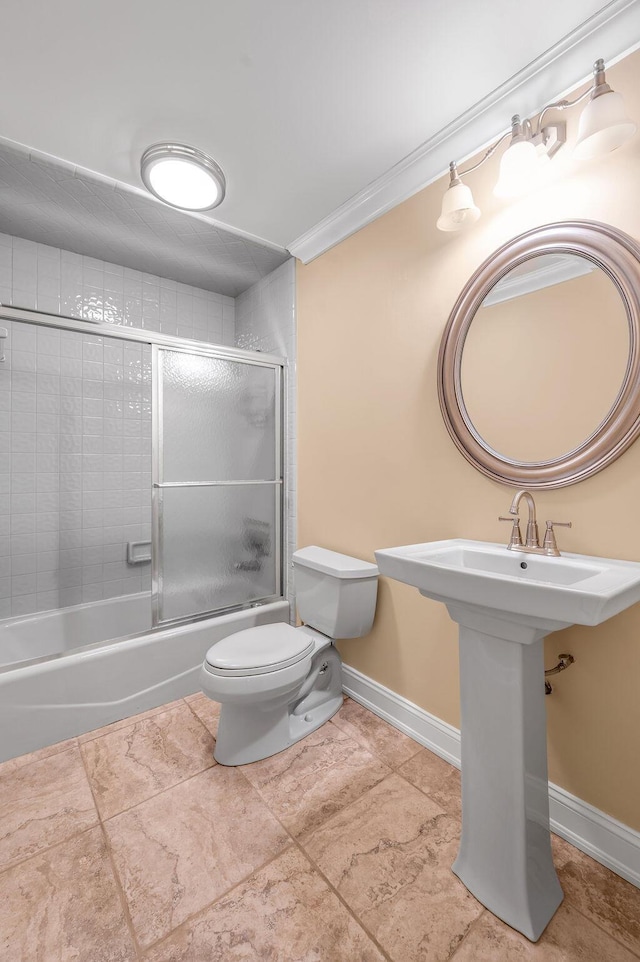 full bathroom with toilet, baseboards, bath / shower combo with glass door, and ornamental molding