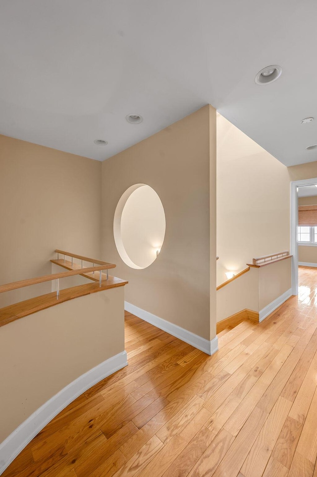 spare room with baseboards, hardwood / wood-style floors, and recessed lighting
