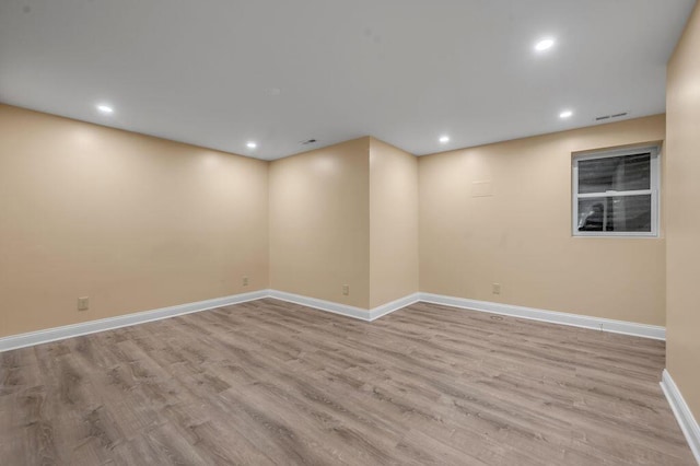 spare room featuring visible vents, wood finished floors, baseboards, and recessed lighting