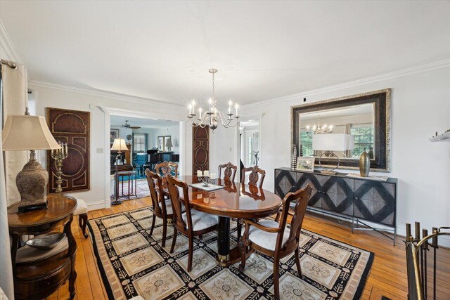 living room with a fireplace, wood finished floors, baseboards, crown molding, and recessed lighting