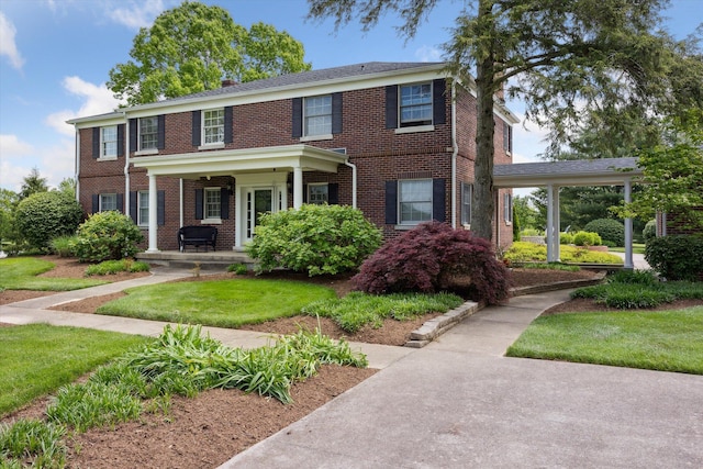 view of front of house with a chimney, a front yard, and a wooden deck