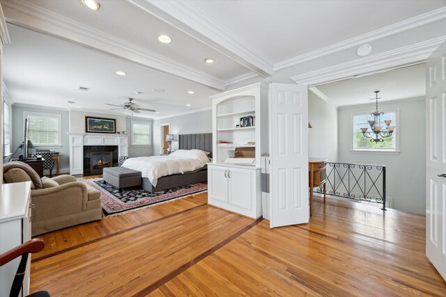 exercise area with ceiling fan, wood finished floors, baseboards, ornamental molding, and recessed lighting