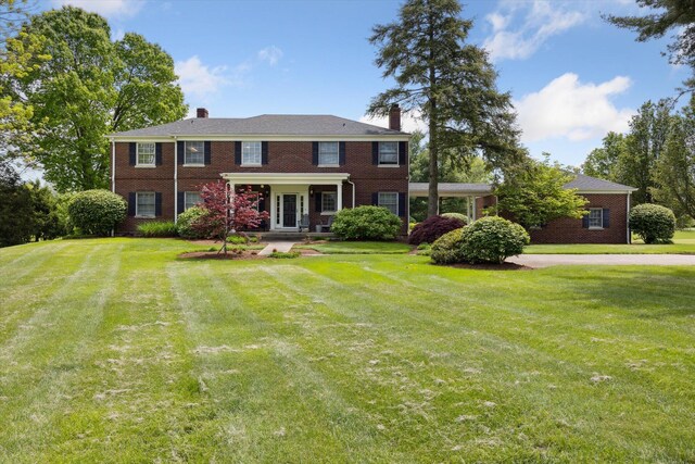 view of front of home featuring french doors, a chimney, and a patio area