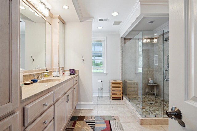 bathroom featuring a garden tub, crown molding, and tile patterned floors