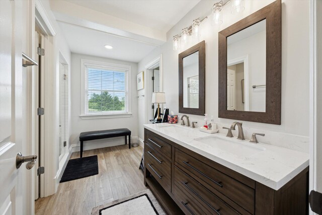 full bathroom featuring a stall shower, toilet, baseboards, and wood finished floors