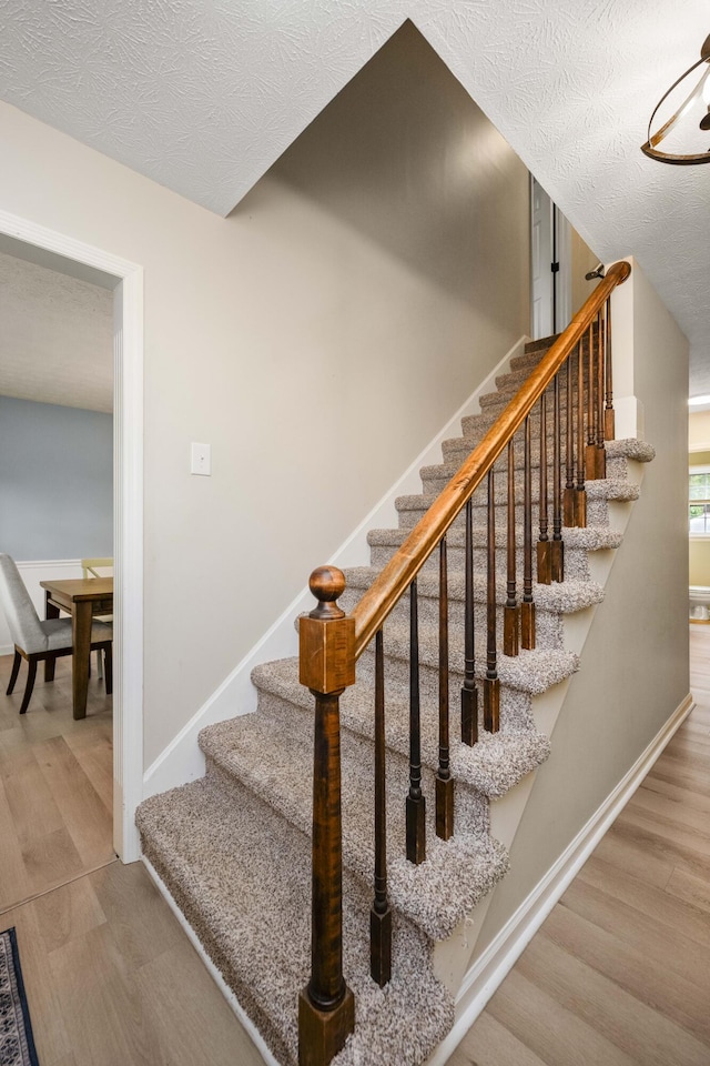 2912 Jason Ct, Lexington, KY 40503 - staircase with wood finished floors, baseboards, and a textured ceiling