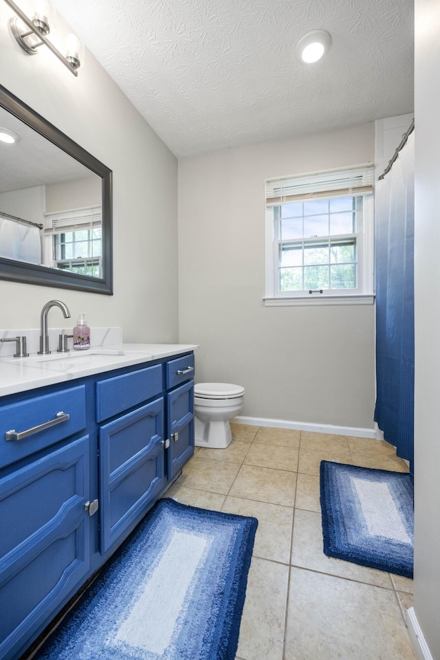 2912 Jason Ct, Lexington, KY 40503 - full bathroom featuring a textured ceiling, vanity, toilet, tile patterned flooring, and baseboards