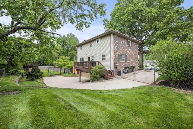 2912 Jason Ct, Lexington, KY 40503 - back of house with a deck, a gate, a patio, concrete driveway, and an attached garage
