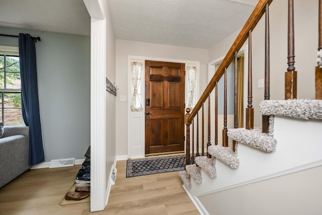 2912 Jason Ct, Lexington, KY 40503 - foyer with light wood finished floors, stairway, baseboards, and a textured ceiling