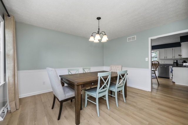 2912 Jason Ct, Lexington, KY 40503 - dining space featuring light wood-type flooring, a chandelier, and a textured ceiling