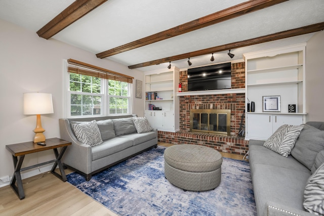 2912 Jason Ct, Lexington, KY 40503 - living room with wood finished floors, a fireplace, beamed ceiling, baseboards, and rail lighting
