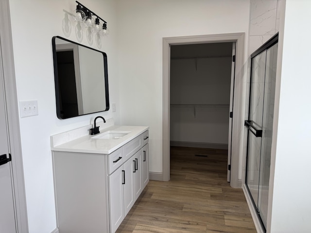 66 Driftwood Way, Corbin, KY 40701 - full bath featuring a stall shower, wood finished floors, vanity, a spacious closet, and baseboards