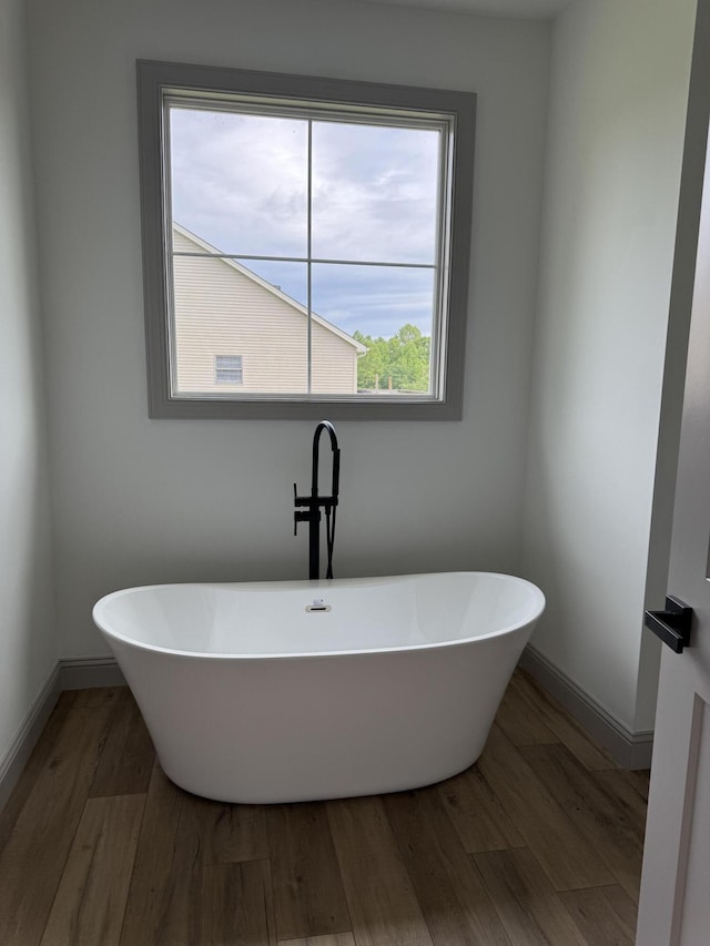66 Driftwood Way, Corbin, KY 40701 - full bathroom with wood finished floors, a freestanding tub, and baseboards