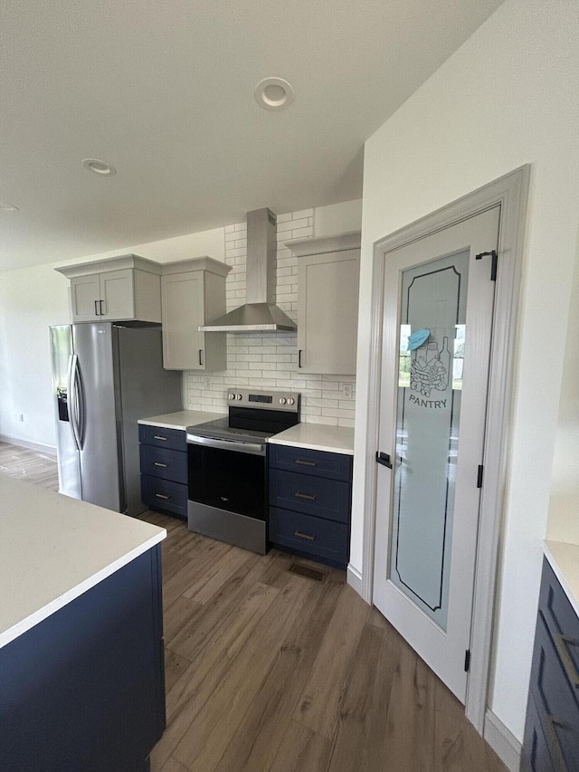 66 Driftwood Way, Corbin, KY 40701 - kitchen featuring wall chimney exhaust hood, stainless steel appliances, dark wood finished floors, light countertops, and backsplash