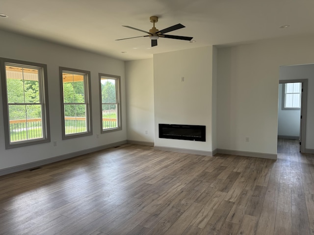 66 Driftwood Way, Corbin, KY 40701 - unfurnished living room with wood finished floors, ceiling fan, and a fireplace