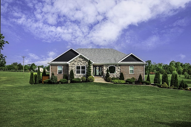 craftsman-style home with a front lawn, stone siding, and brick siding