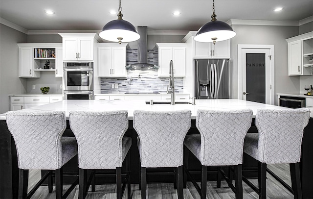 101 Creek Ridge Dr, Nicholasville, KY 40356 - kitchen featuring appliances with stainless steel finishes, open shelves, wall chimney range hood, a spacious island, and tasteful backsplash