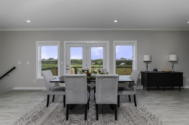 dining room featuring ornamental molding, wood finished floors, baseboards, and recessed lighting