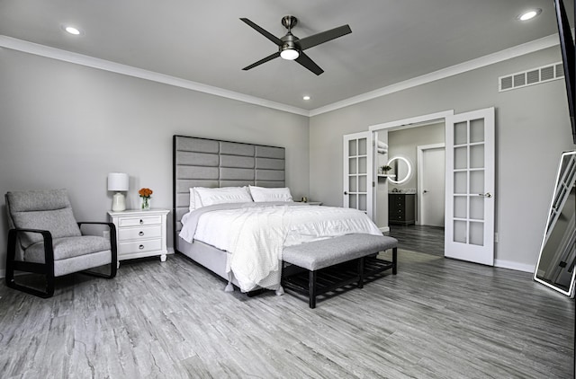 bedroom featuring french doors, crown molding, wood finished floors, recessed lighting, and baseboards