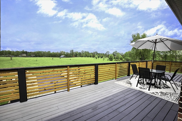 deck featuring outdoor dining space and view of scattered trees